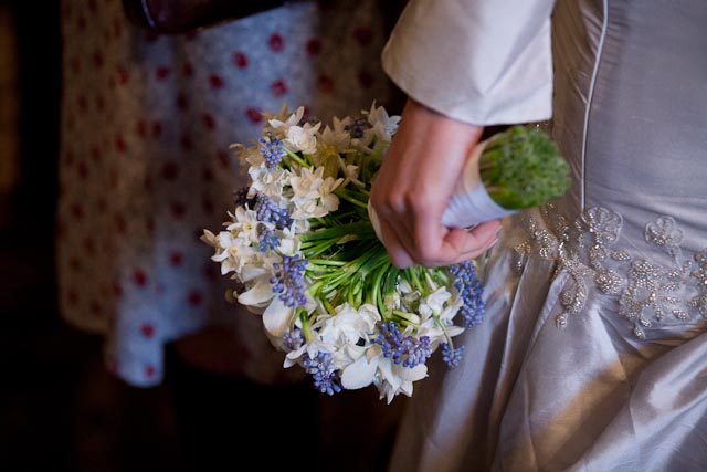 Natural Wedding Bouquet with Spring Flowers and detail of wedding dress